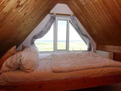 Ein Bett oder Betten in einem Zimmer der Unterkunft Ferienhaus am Schilfufer in Barth
