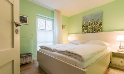 Ein Bett oder Betten in einem Zimmer der Unterkunft Wellenzauber