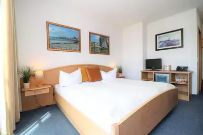 Ein Bett oder Betten in einem Zimmer der Unterkunft Deutsches Haus Zimmer 26
