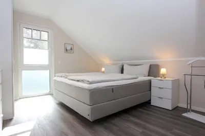 Ein Bett oder Betten in einem Zimmer der Unterkunft Darßkönig