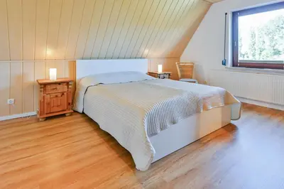 Ein Bett oder Betten in einem Zimmer der Unterkunft Ferienhaus Heideweg