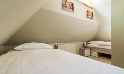 Ein Bett oder Betten in einem Zimmer der Unterkunft Muschel