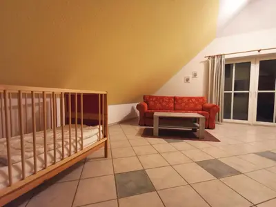 Ein Bett oder Betten in einem Zimmer der Unterkunft UNSERE FAMILIENPERLE MIT ZWEI BALKONEN im Bernsteinhaus Zingst - 7 -
