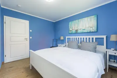 Ein Bett oder Betten in einem Zimmer der Unterkunft Haus Muschelsucher, Birkenstraße SIeben a, App 2