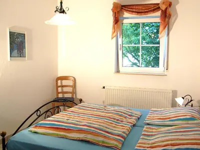 Ein Bett oder Betten in einem Zimmer der Unterkunft Birkmaase 16 - Komfort FeWo im 4-Sterne-Ferienhaus Manuela EG