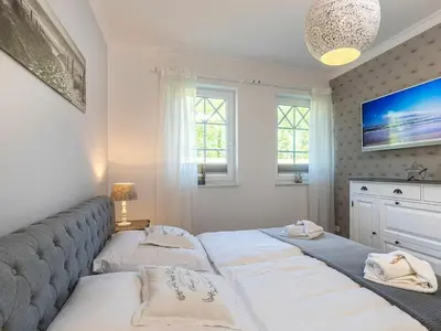 Ein Bett oder Betten in einem Zimmer der Unterkunft Villa Strandblick 6