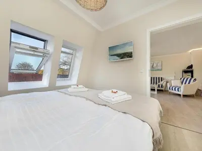 Ein Bett oder Betten in einem Zimmer der Unterkunft Villa Strandblick 12