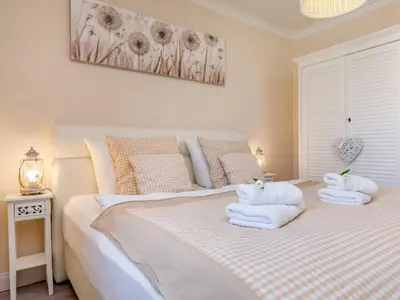 Ein Bett oder Betten in einem Zimmer der Unterkunft Villa Strandblick 5