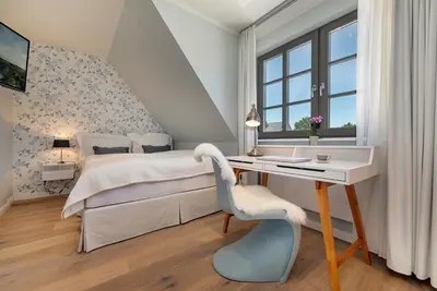 Ein Bett oder Betten in einem Zimmer der Unterkunft Zur Heiderose Haus 10 Kleine Flucht