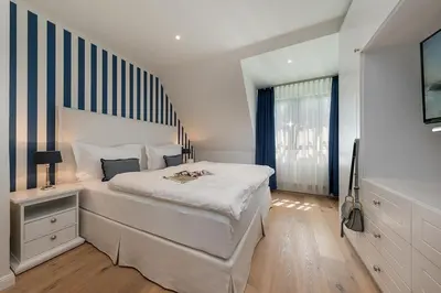 Ein Bett oder Betten in einem Zimmer der Unterkunft Zur Heiderose Haus 10 Kleine Flucht