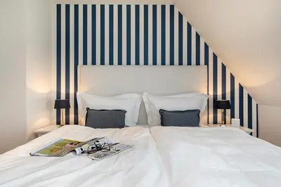 Ein Bett oder Betten in einem Zimmer der Unterkunft Zur Heiderose Haus 10 Kleine Flucht