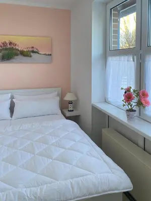 Ein Bett oder Betten in einem Zimmer der Unterkunft Kapitänsgarten W16