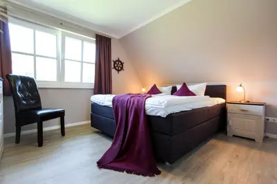 Ein Bett oder Betten in einem Zimmer der Unterkunft Seeschwalbe 5 - Sauna & Kamin am Bodden