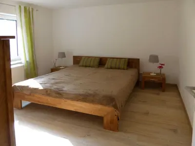 Ein Bett oder Betten in einem Zimmer der Unterkunft Ferienwohnungen am Waldessaum