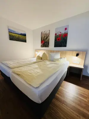 Ein Bett oder Betten in einem Zimmer der Unterkunft Ferienhotel Alter Bahnhof garni