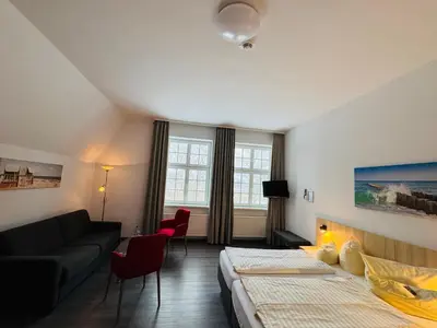 Ein Bett oder Betten in einem Zimmer der Unterkunft Ferienhotel Alter Bahnhof garni