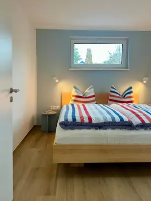 Ein Bett oder Betten in einem Zimmer der Unterkunft H24ZINGST - Das Ferienhaus