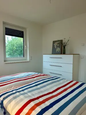 Ein Bett oder Betten in einem Zimmer der Unterkunft H24ZINGST - Das Ferienhaus