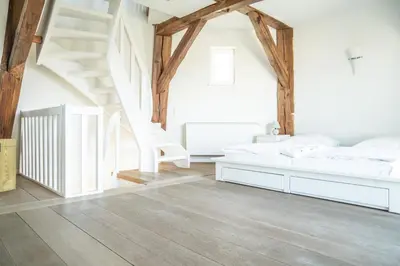 Ein Bett oder Betten in einem Zimmer der Unterkunft Darßer Mühle