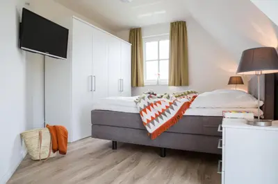 Ein Bett oder Betten in einem Zimmer der Unterkunft Ferienhaus Schilfrohrsaenger 54