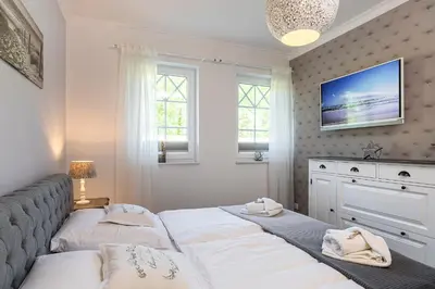 Ein Bett oder Betten in einem Zimmer der Unterkunft Villa Strandblick 2