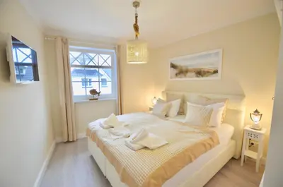 Ein Bett oder Betten in einem Zimmer der Unterkunft Villa Strandblick 5