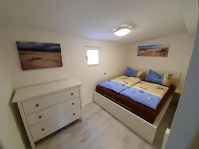 Ein Bett oder Betten in einem Zimmer der Unterkunft Haus auf der alten Düne 2