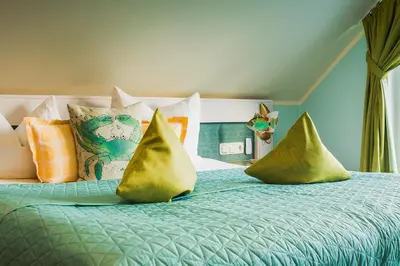 Ein Bett oder Betten in einem Zimmer der Unterkunft Hotel Garni Inselparadies Zingst