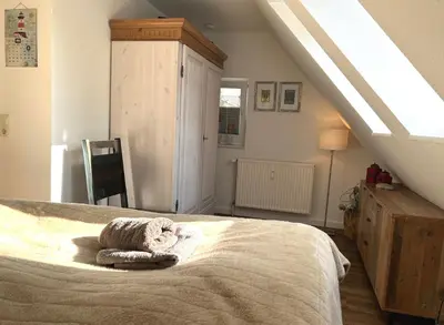 Ein Bett oder Betten in einem Zimmer der Unterkunft Kormoran Muschelsucher
