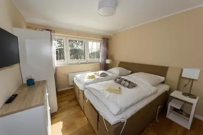 Ein Bett oder Betten in einem Zimmer der Unterkunft Premiumhaus Bodden und Mehr-Brise