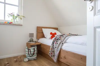 Ein Bett oder Betten in einem Zimmer der Unterkunft Ferienhaus Schilfrohrsänger 8