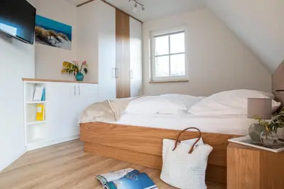 Ein Bett oder Betten in einem Zimmer der Unterkunft Ferienhaus Schilfrohrsänger 8