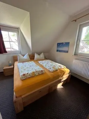 Ein Bett oder Betten in einem Zimmer der Unterkunft Am Deich 42