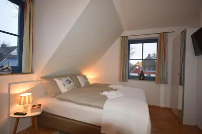 Ein Bett oder Betten in einem Zimmer der Unterkunft Ostseebrise FH 1