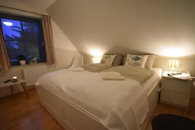 Ein Bett oder Betten in einem Zimmer der Unterkunft Ostseebrise FH 1