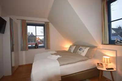 Ein Bett oder Betten in einem Zimmer der Unterkunft Ostseebrise FH 3