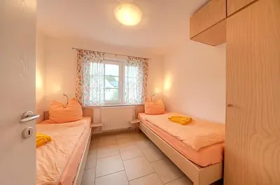 Ein Bett oder Betten in einem Zimmer der Unterkunft Strandglück FH 1