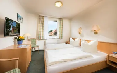 Ein Bett oder Betten in einem Zimmer der Unterkunft Frühstückspension Landhaus Lange