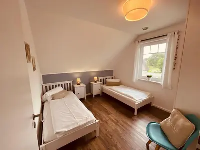 Ein Bett oder Betten in einem Zimmer der Unterkunft Ferienwohnung London in Born