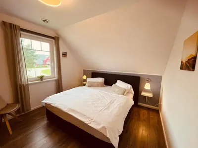 Ein Bett oder Betten in einem Zimmer der Unterkunft Ferienwohnung London in Born