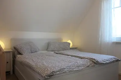 Ein Bett oder Betten in einem Zimmer der Unterkunft Ferienwohnung F 86 in Born