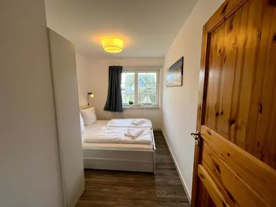 Ein Bett oder Betten in einem Zimmer der Unterkunft Ferienhaus Fiete in Wieck