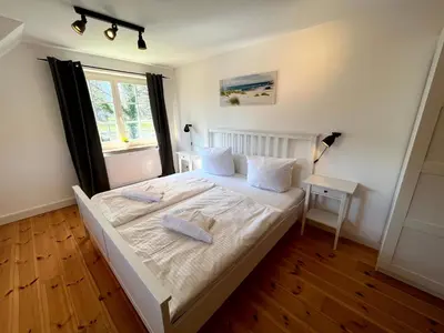 Ein Bett oder Betten in einem Zimmer der Unterkunft Ferienhaus Fiete in Wieck