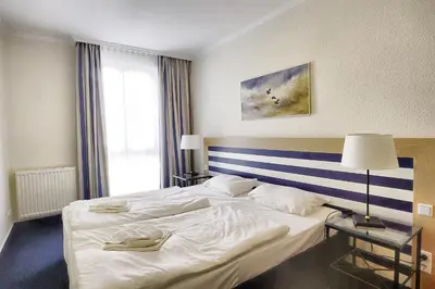 Ein Bett oder Betten in einem Zimmer der Unterkunft Am Kurhaus 211 PP 66