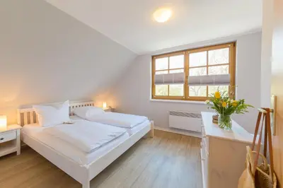 Ein Bett oder Betten in einem Zimmer der Unterkunft Doppelhaus am Deich 12