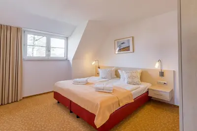 Ein Bett oder Betten in einem Zimmer der Unterkunft BSW-Ferienwohnungen Zingst