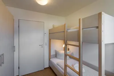 Ein Bett oder Betten in einem Zimmer der Unterkunft BSW-Ferienwohnungen Zingst