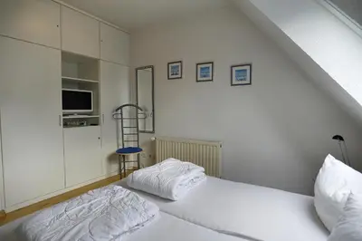Ein Bett oder Betten in einem Zimmer der Unterkunft Kranich III, Whg 14