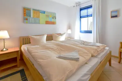 Ein Bett oder Betten in einem Zimmer der Unterkunft Ut kiek, Sprotte