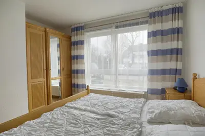 Ein Bett oder Betten in einem Zimmer der Unterkunft Sandstrand FW 17